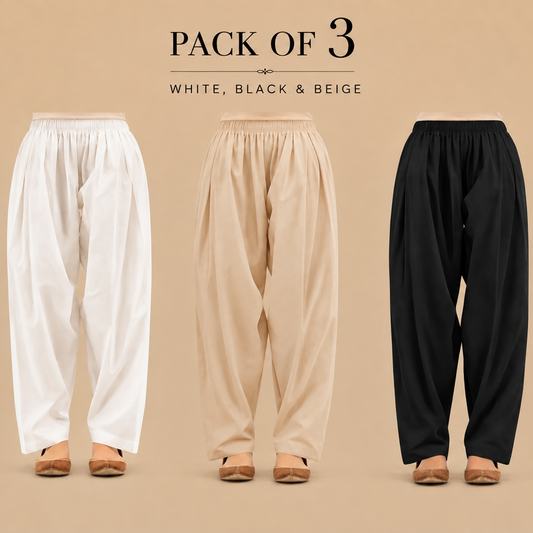Three pairs of loose, high-waisted pleated shalwars shown from the back on a beige studio background, labeled 'PACK OF 3' with color options 'WHITE, BLACK & BEIGE'. The pants are shown in white, beige, and black, paired with tan flat shoes.